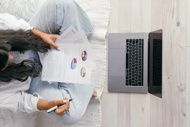 Woman analyzing charts and graphs for statistics homework Woman analyzing charts and graphs for statistics homework