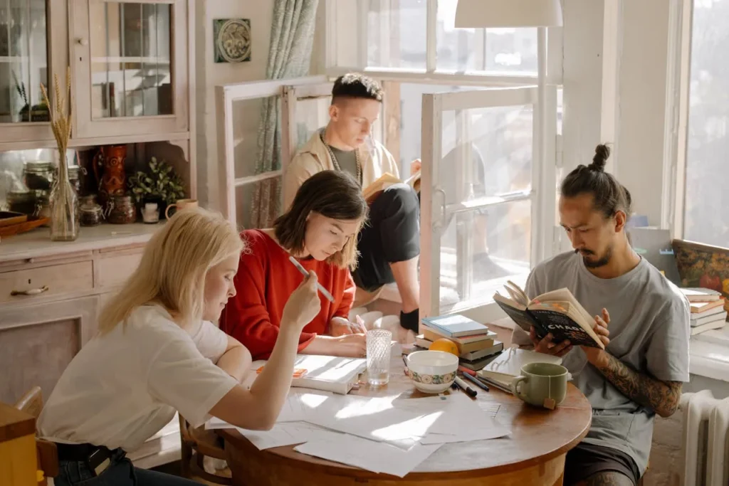 Students studying together in a bright kitchen Students studying together in a bright kitchen