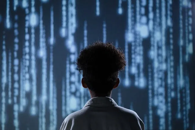 Student looking at digital code projection on wall Student looking at digital code projection on wall